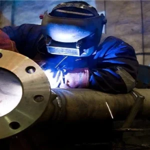 welder welding a flange on a pressure vessel nozzel